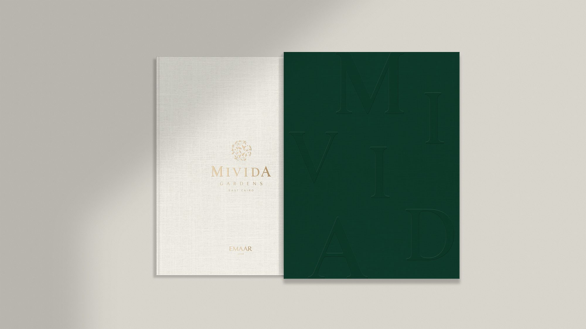 The Mivida Gardens brochure — cream and forest green